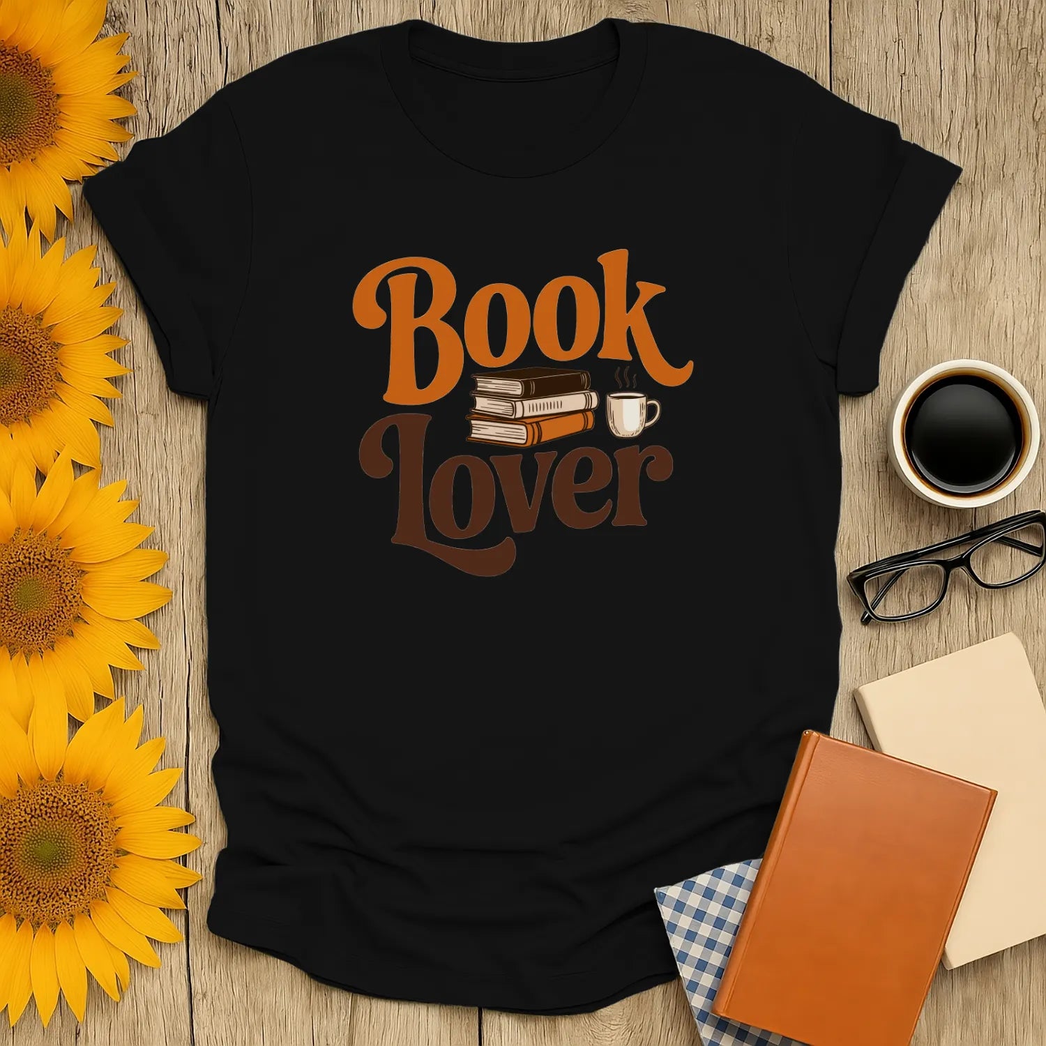 Cozy black book lover t-shirt featuring books and a coffee mug, perfect for readers and cat lovers.