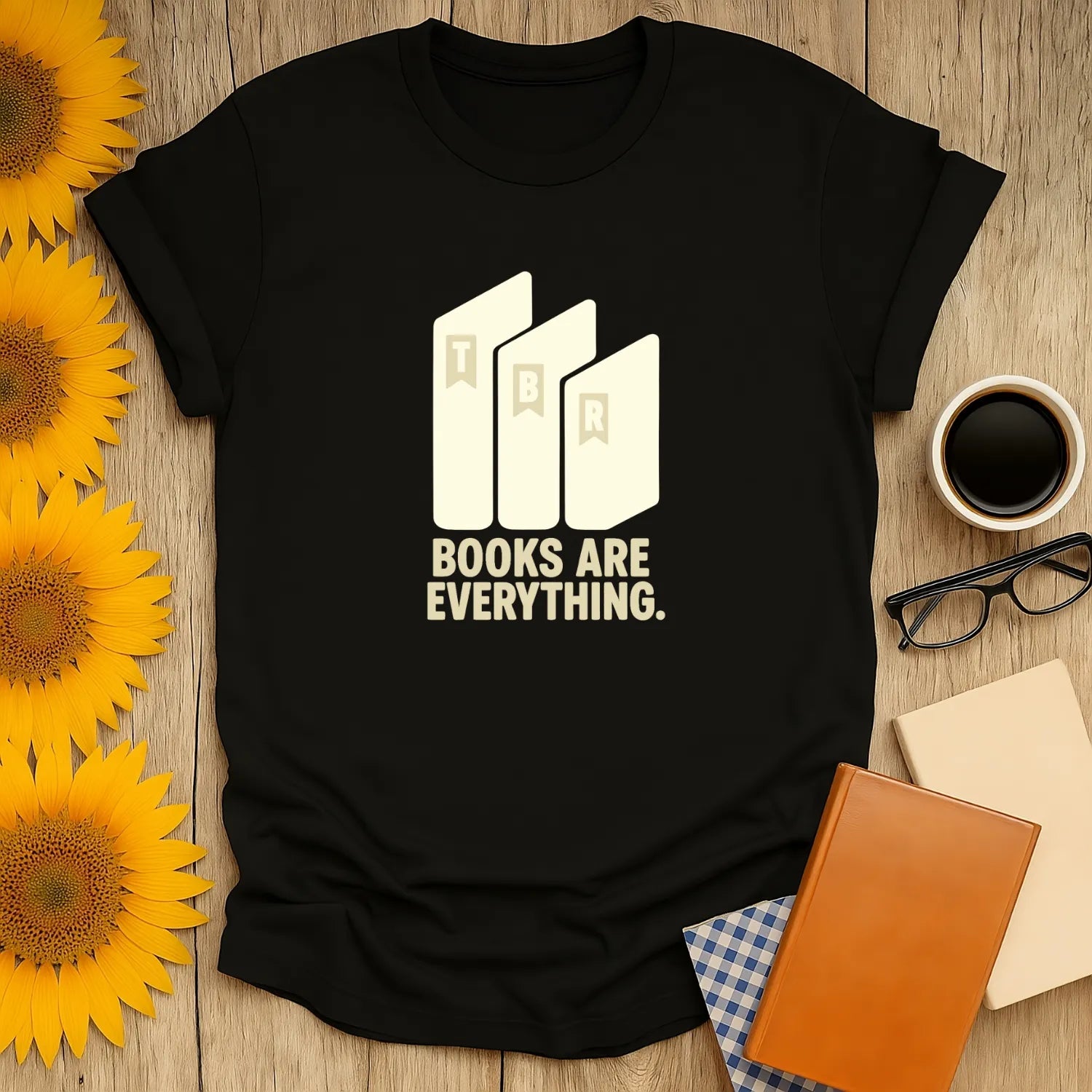 Black book lover tee with stacked books illustration and the phrase 'BOOKS ARE EVERYTHING.' Perfect for readers who adore cats, coffee, or tea.