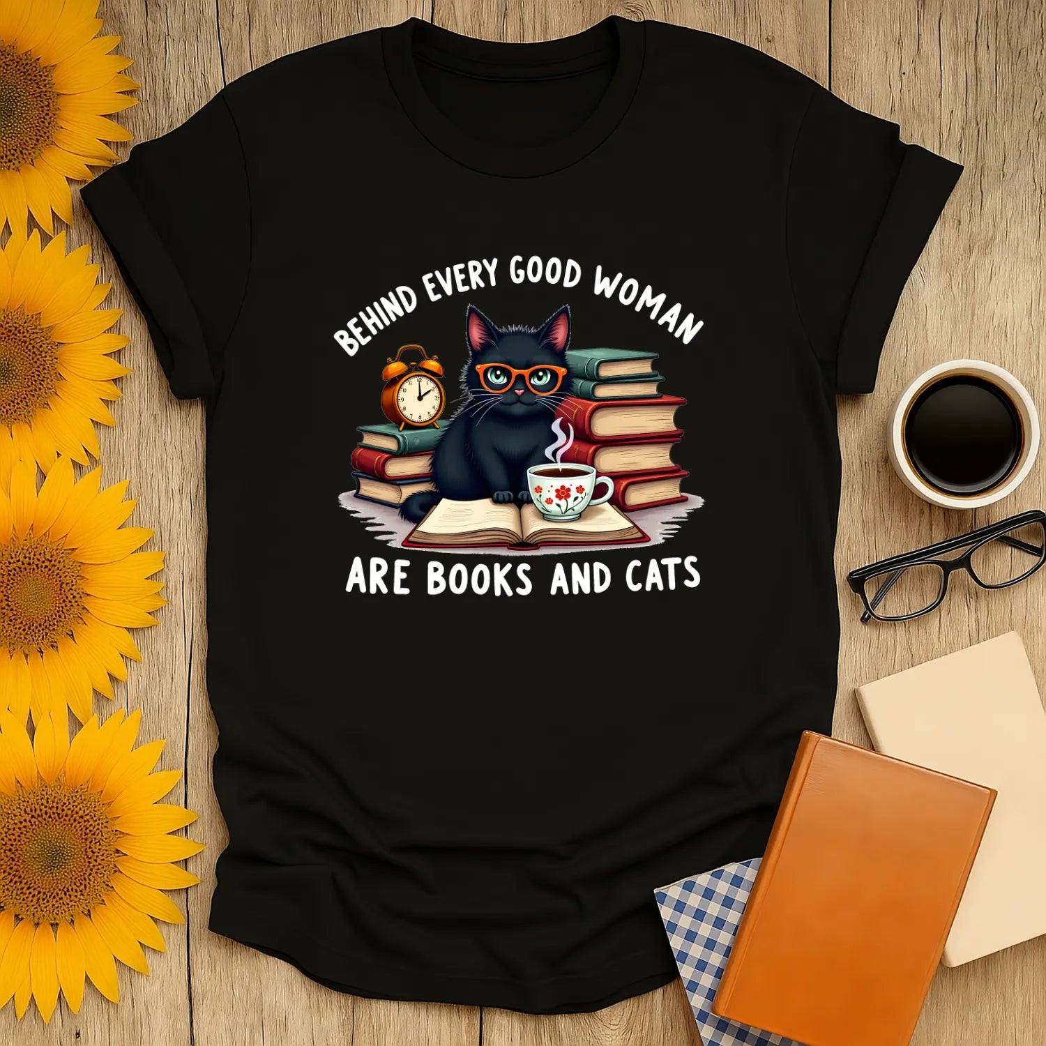 Funny reading tee featuring a cute black cat, books, a clock, and a tea cup with the text 'Behind Every Good Woman Are Books and Cats'.