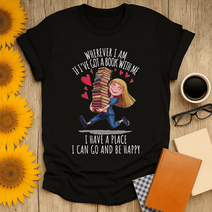 Black t-shirt with book lover design featuring girl holding stacked books with text 'Wherever I am, I have a place to be happy'.