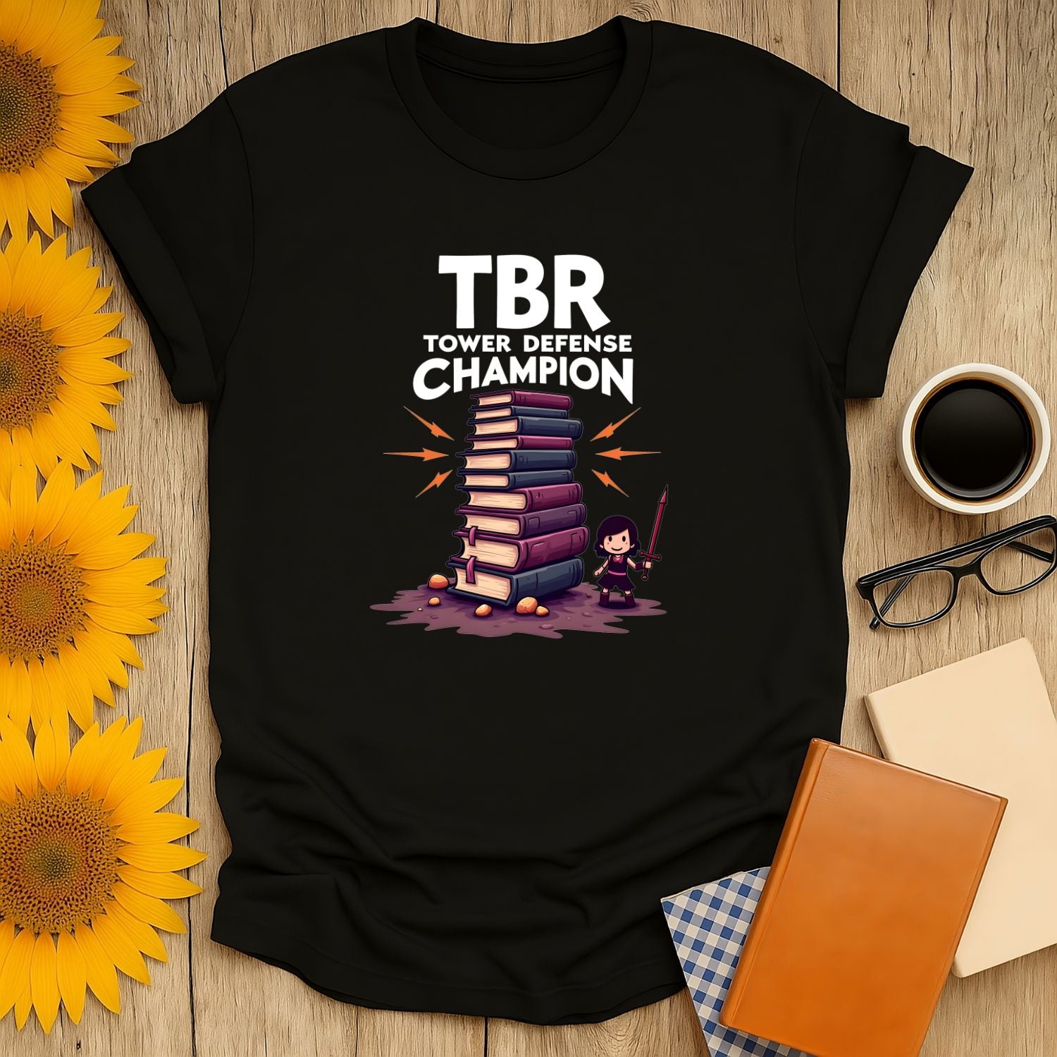 TBR Defender T-Shirt featuring a graphic of stacked books and a character, perfect for book lovers.