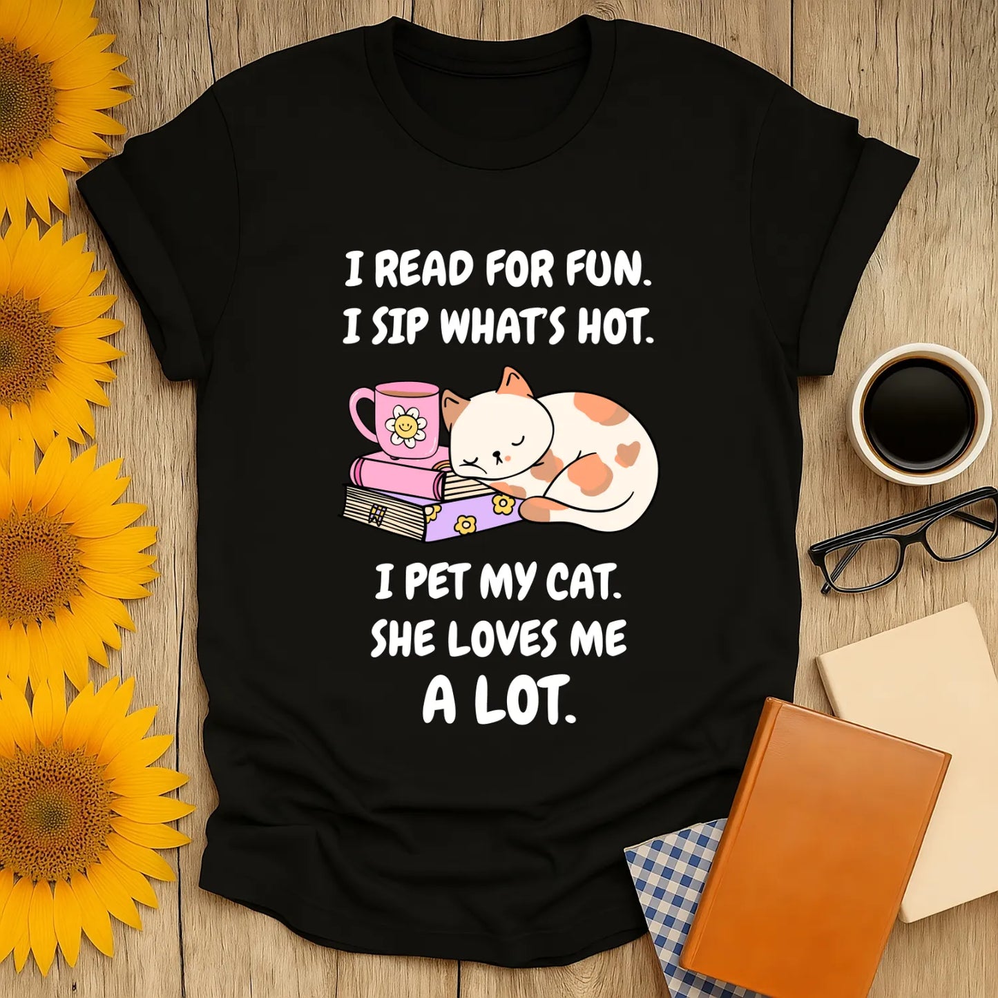 Cozy black tee featuring a cute cat, a mug, and playful text about reading, sipping, and cat love—perfect for book lovers!