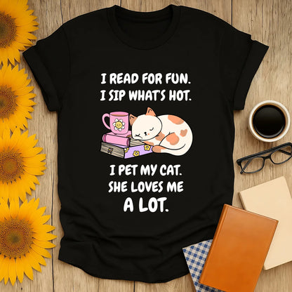 Cozy black tee featuring a cute cat, a mug, and playful text about reading, sipping, and cat love—perfect for book lovers!
