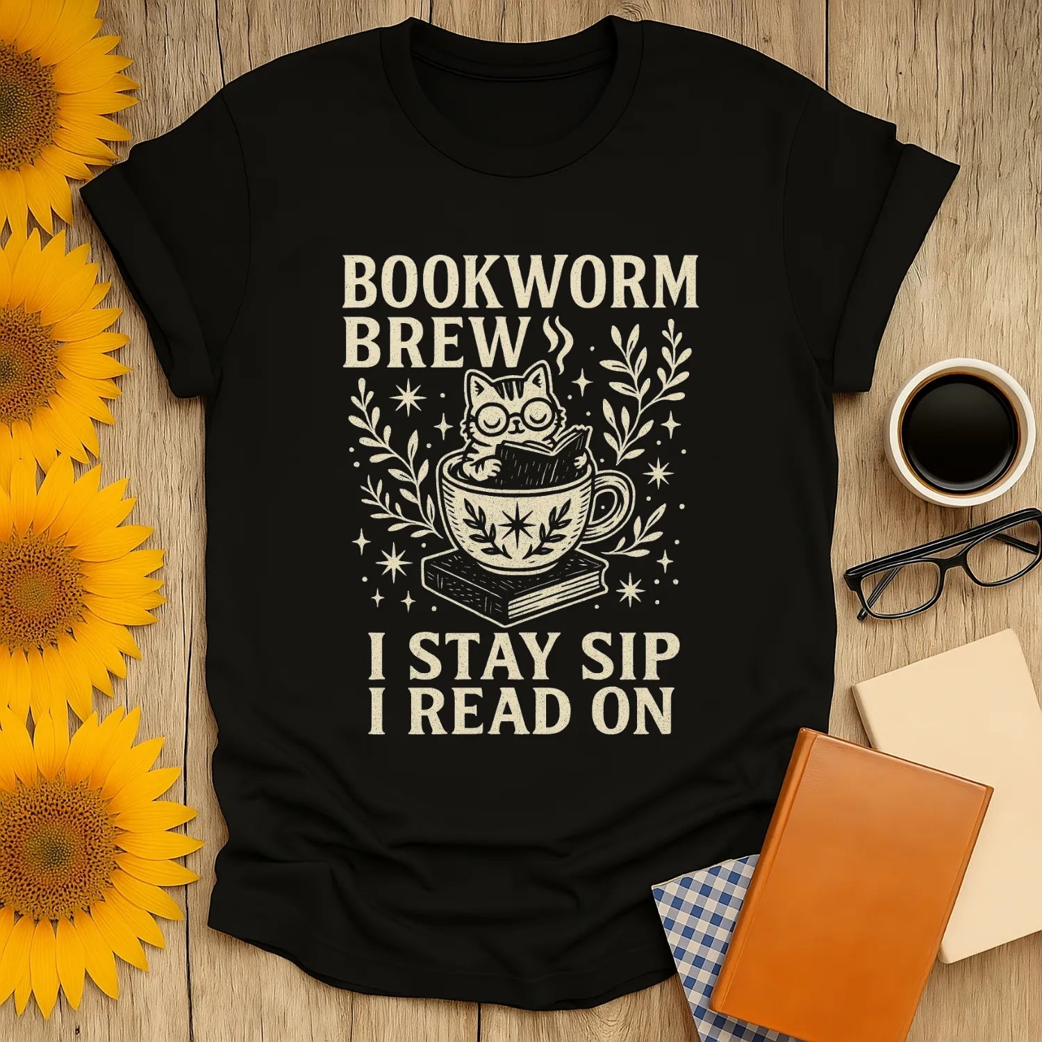 Bookworm Brew t-shirt features a cat in a teacup with text 'I Stay Sip I Read On'—perfect for cozy reading days!