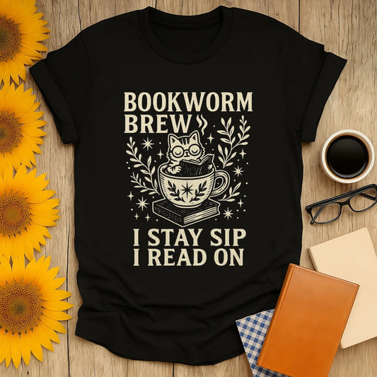 Bookworm Brew t-shirt features a cat in a teacup with text 'I Stay Sip I Read On'—perfect for cozy reading days!