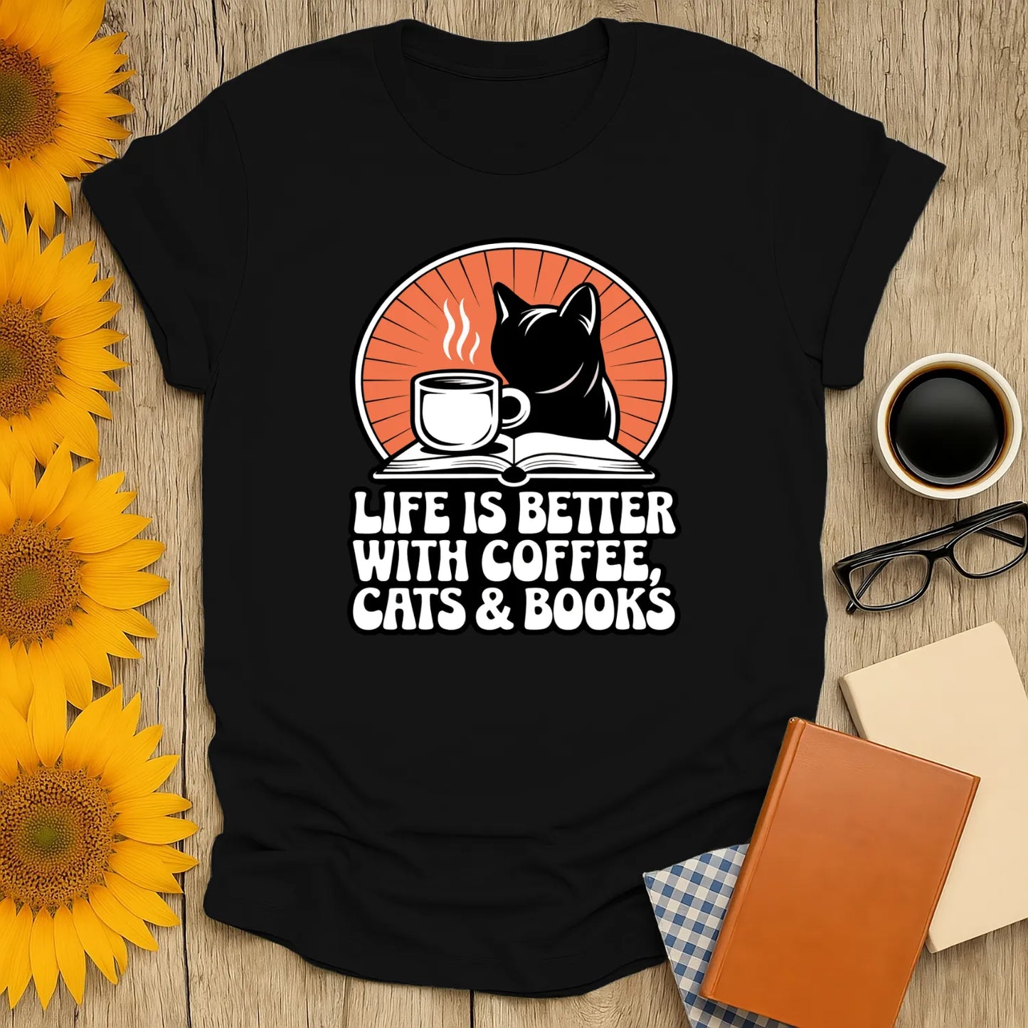 Funny reading tee featuring a black cat, coffee cup, and text ‘Life is better with coffee, cats & books’—perfect for book lovers!