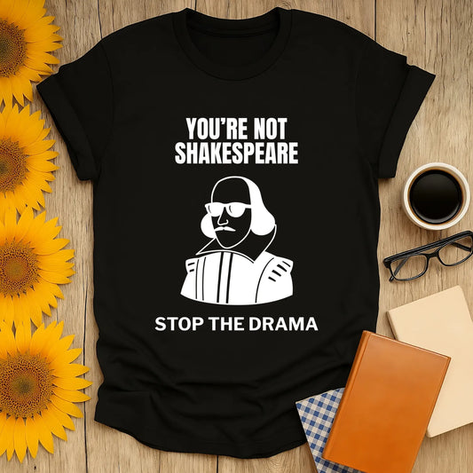Black 'You're Not Shakespeare' shirt with playful illustration, perfect gift for book lovers who enjoy cozy reading with coffee.