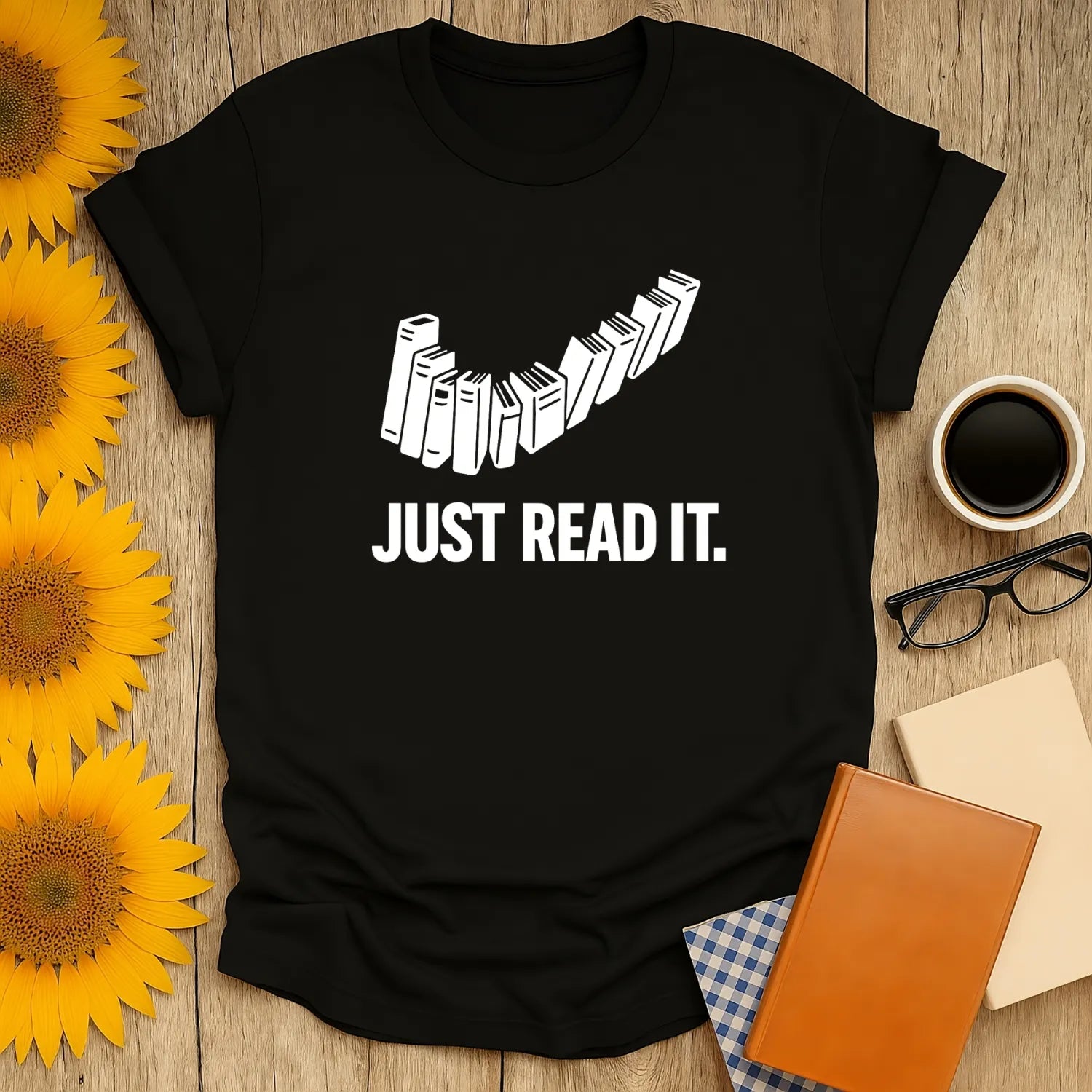 Black Just Read It T-shirt featuring stacked books and bold text. Ideal book lover shirt for cozy reading moments.