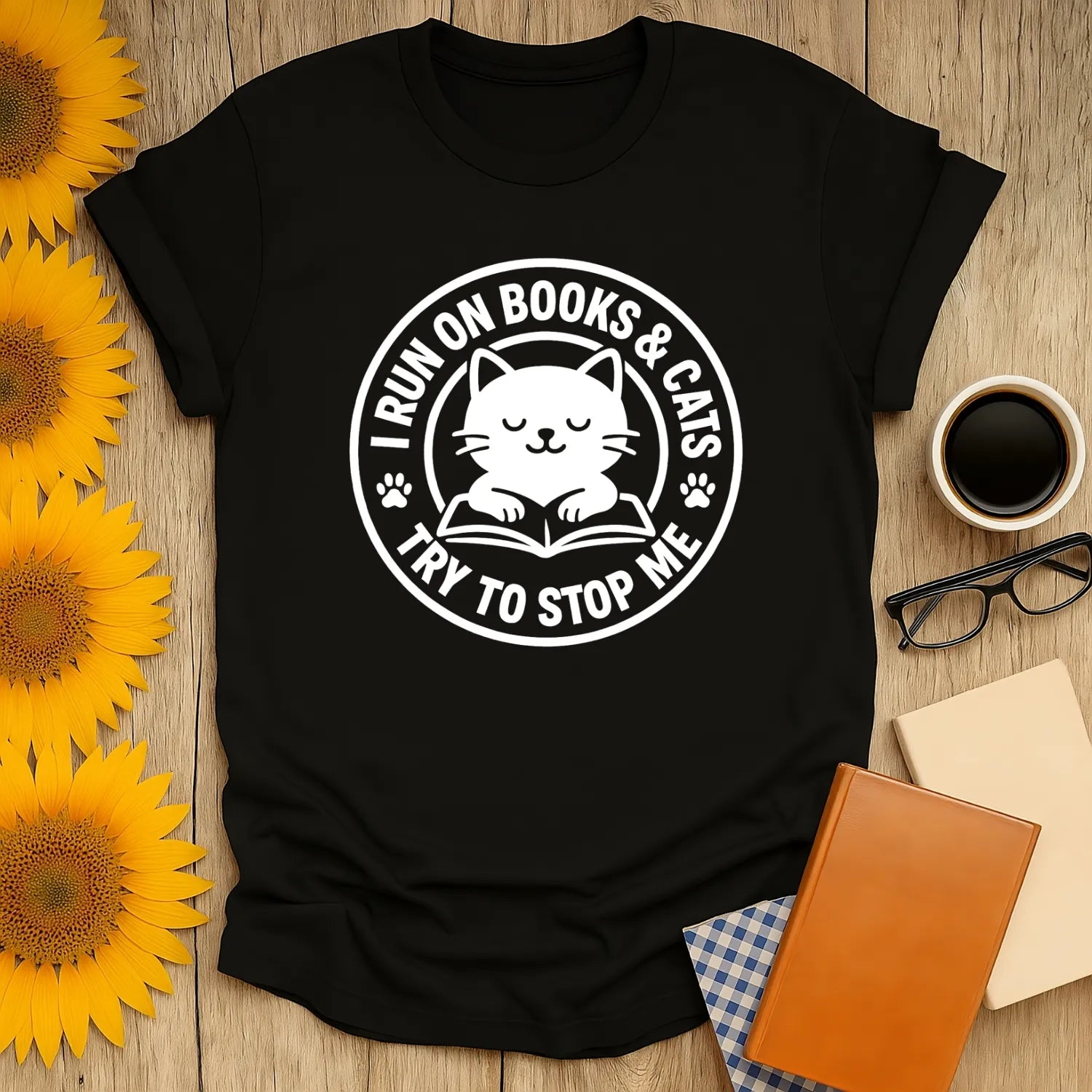 Cozy black cat reading shirt with text: 'I RUN ON BOOKS & CATS TRY TO STOP ME', perfect for book lovers and cat enthusiasts.