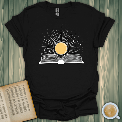 Sunshine Kiss T-Shirt featuring a sun rising from an open book, perfect for book lovers. Soft, unisex fit.