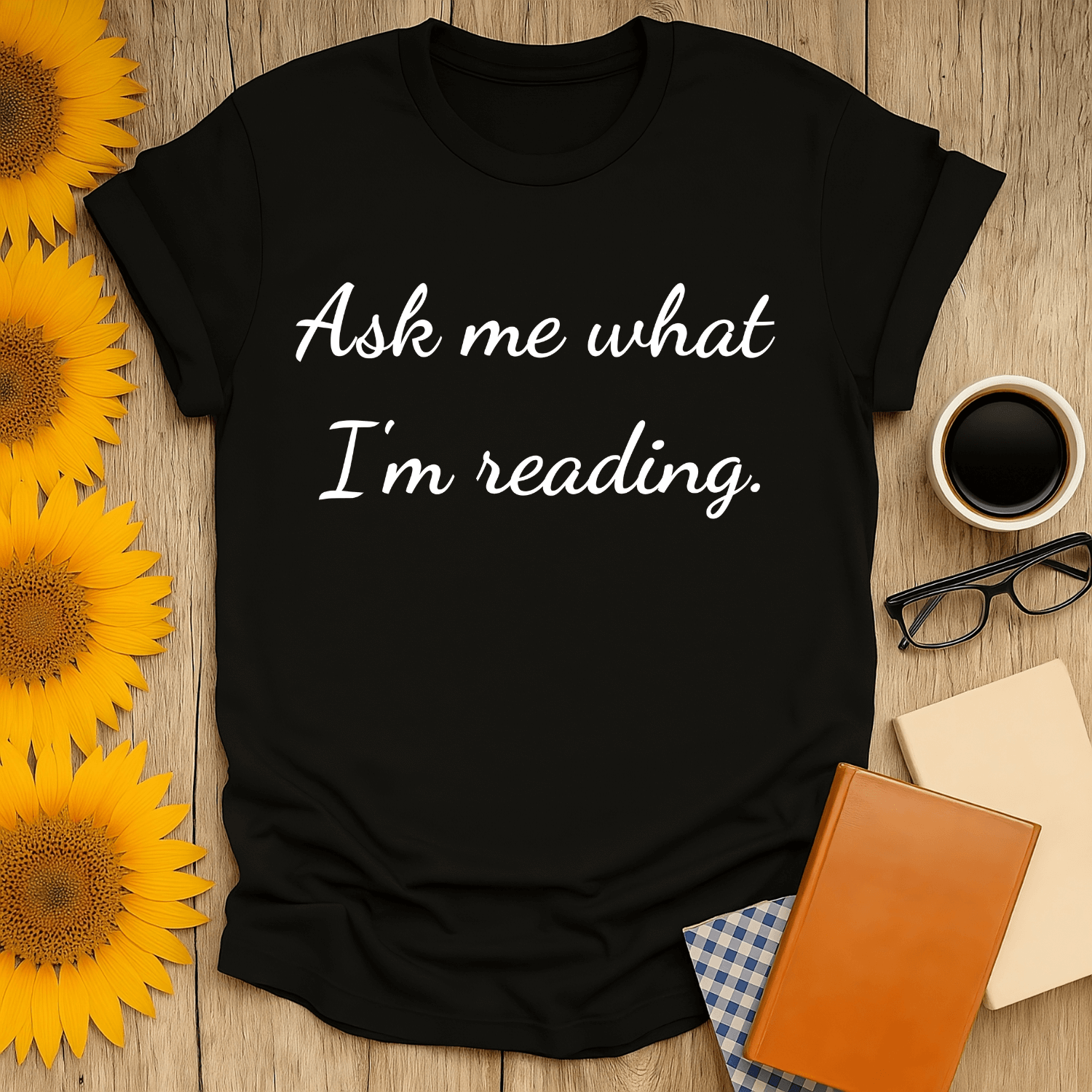 Ask Me T-Shirt in black, perfect for book lovers, featuring the phrase "Ask me what I’m reading" printed on soft cotton.