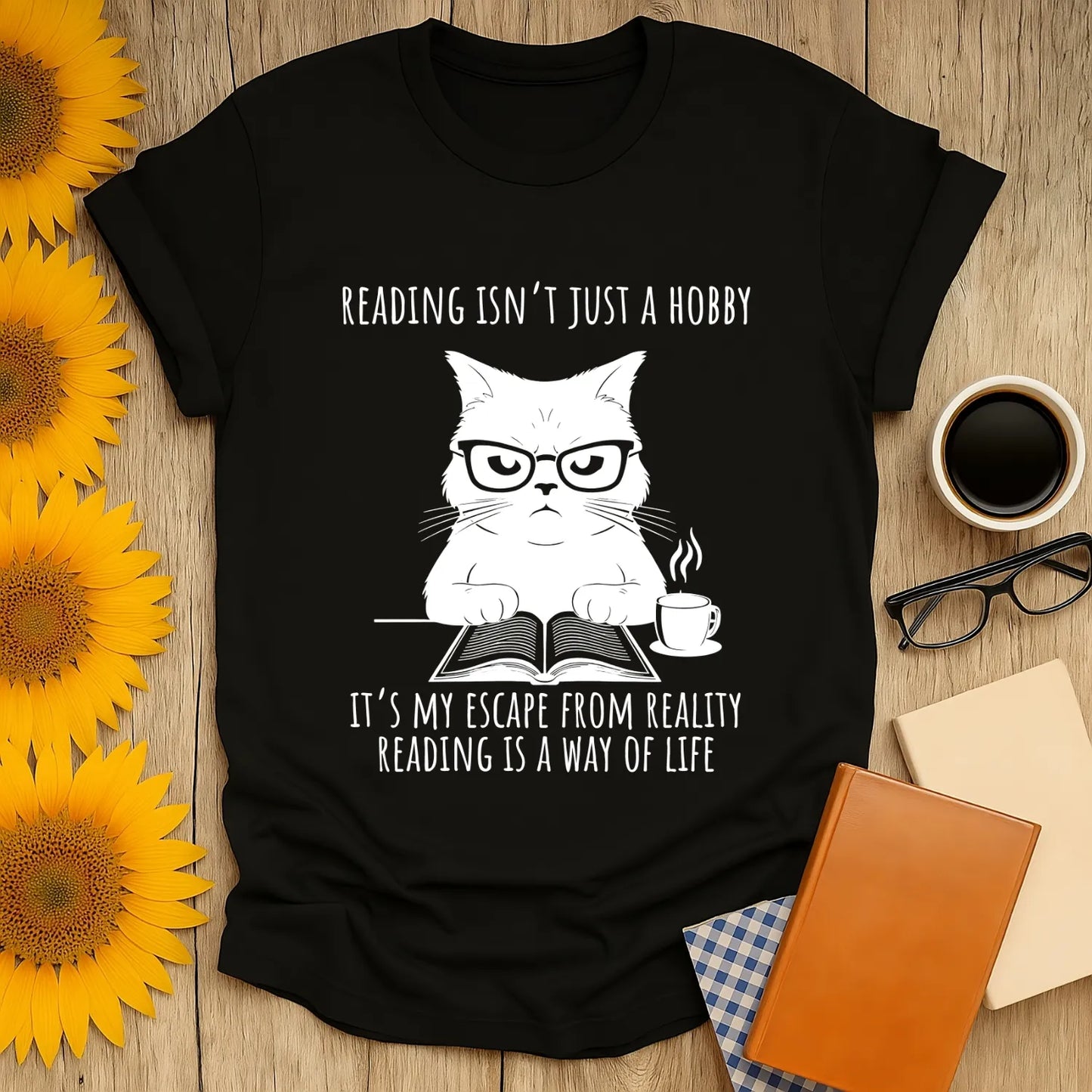 Funny bookworm t-shirt featuring a grumpy cat in glasses with the text: "Reading isn’t just a hobby, it’s my escape from reality"