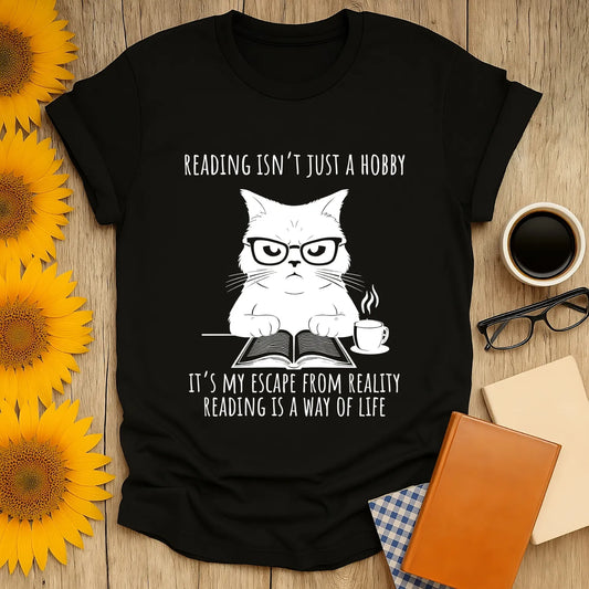 Funny bookworm t-shirt featuring a grumpy cat in glasses with the text: "Reading isn’t just a hobby, it’s my escape from reality"