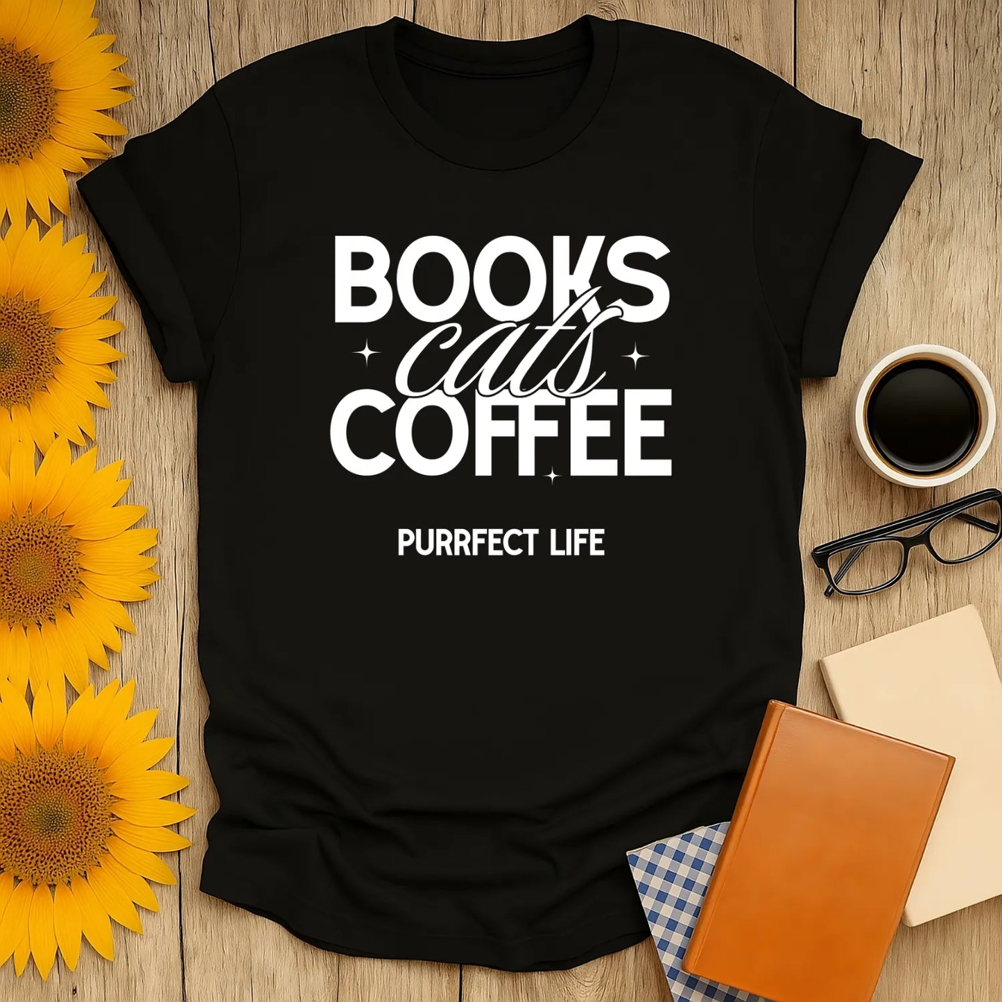 Trio of Joy T-Shirt featuring bold text: "BOOKS, cats, COFFEE, PURRfect LIFE". A cozy book lover shirt ideal for feline fans.