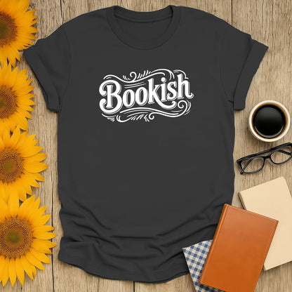 Stylish 'Bookish' t-shirt on a rustic table with coffee, glasses, and books; perfect gift for cozy book lovers.