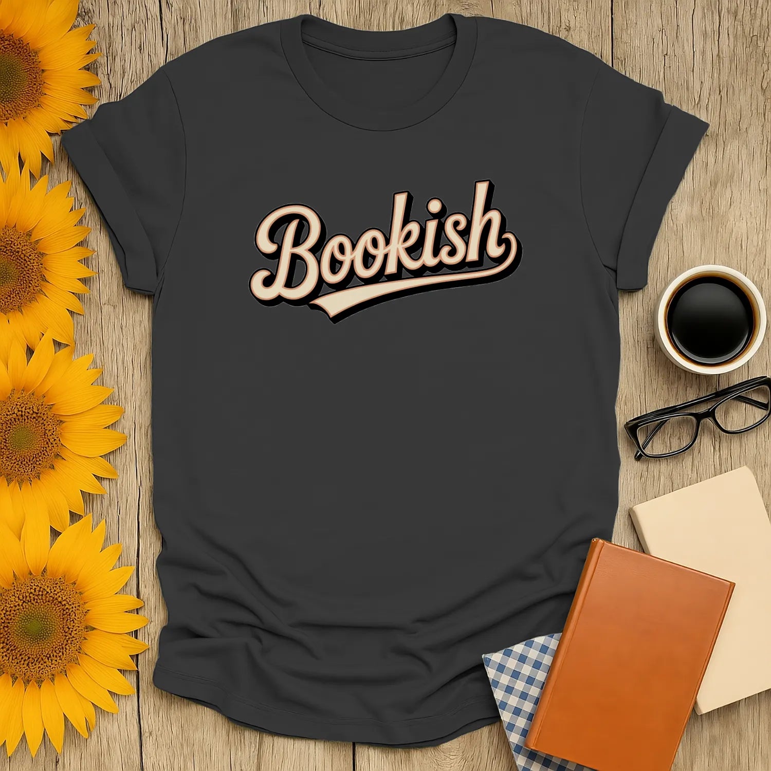 Cozy, dark tee with the word 'Bookish' in a fun, vintage style—perfect for book lovers who enjoy reading with coffee or tea.