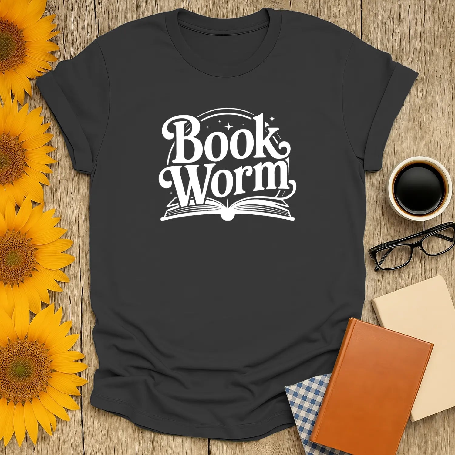 Cozy bookworm t-shirt featuring playful 'Book Worm' text over an open book, perfect for cat, coffee, and tea lovers.