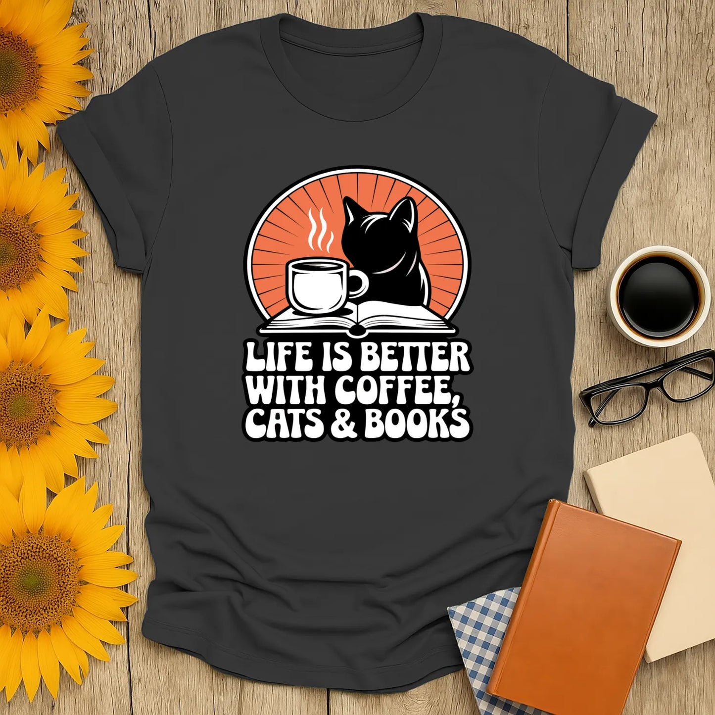 Cozy book lover shirt featuring a cat silhouette, coffee cup, and the phrase 'Life is better with coffee, cats & books'. Perfect gift for readers!