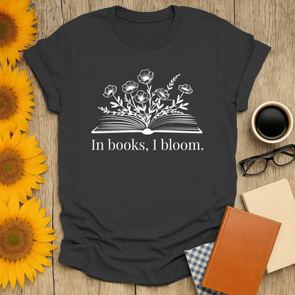 Bloom Through Books T-Shirt features an open book with flowers and the text 'In books, I bloom.' Perfect for cozy readers and book lovers!