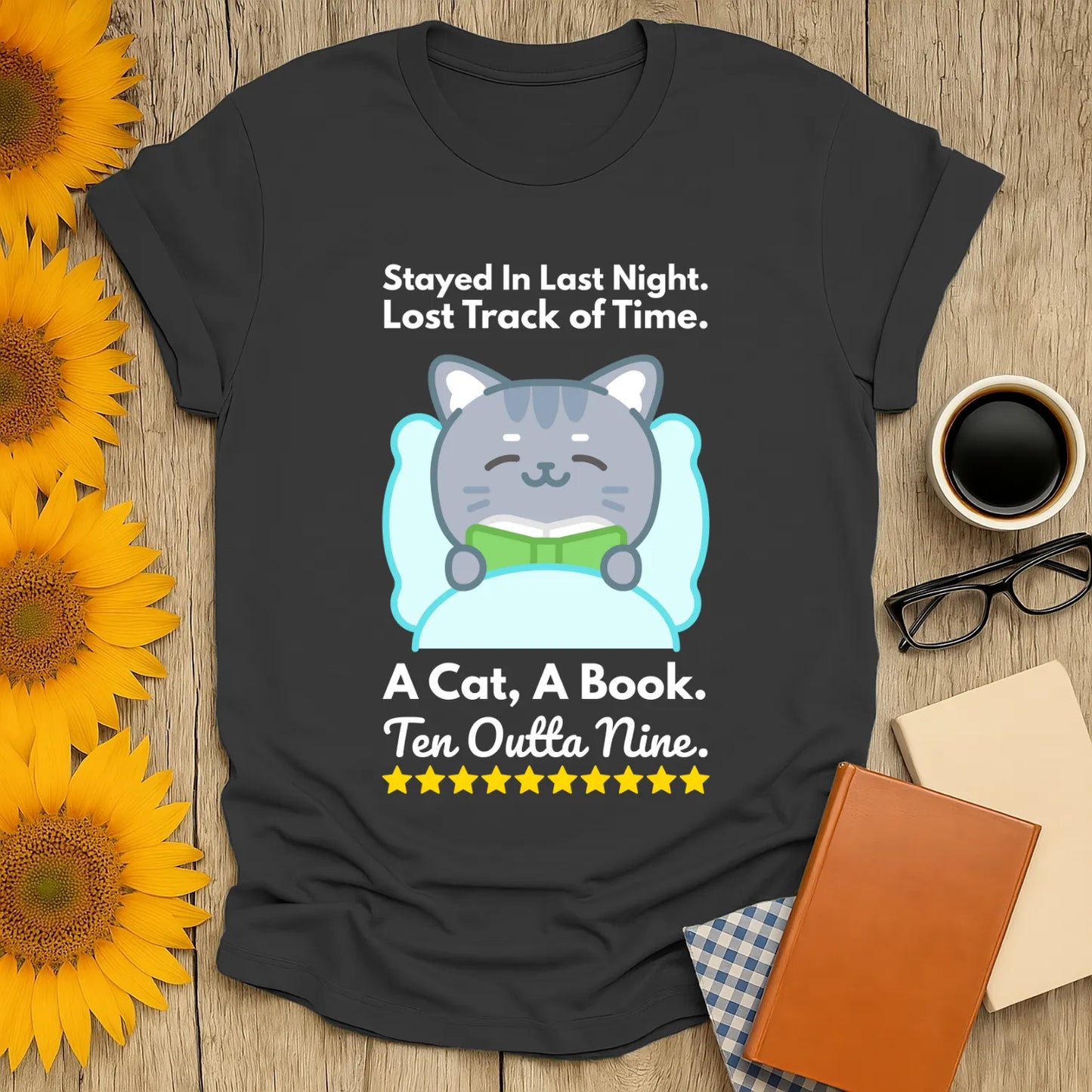 Cozy book lover shirt featuring a cute cat reading with text: "Stayed In Last Night. A Cat, A Book. Ten Outta Nine." Perfect gift for bookworms!