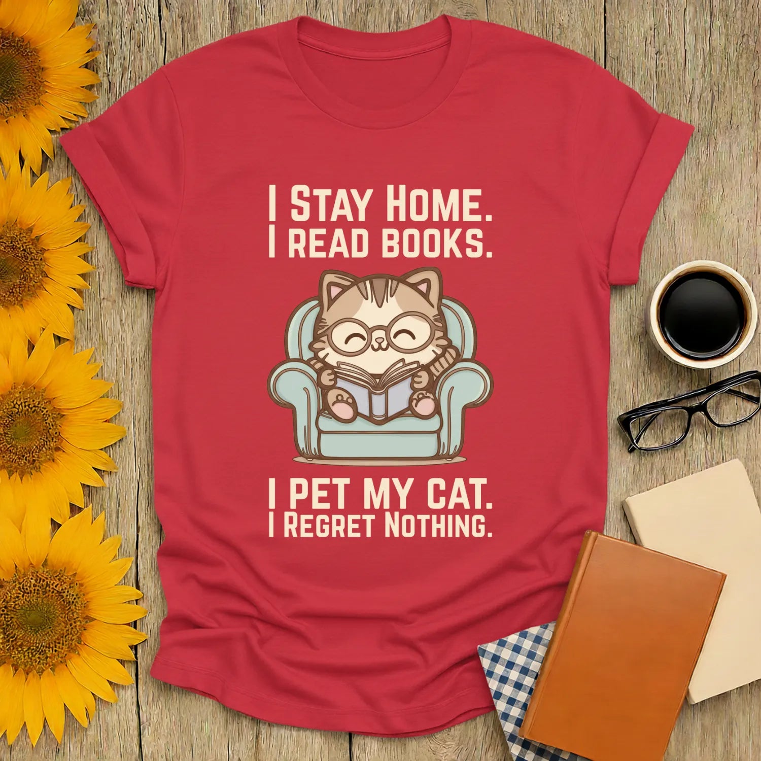 Comfy Cat Reader T-Shirt featuring a cute cat in glasses reading on a blue chair with funny text, perfect for book lovers and cat enthusiasts.