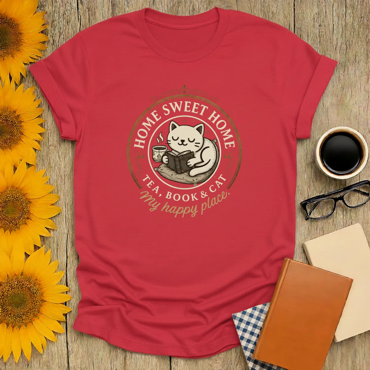 A cozy Happy Place Reader T-Shirt featuring a cute cat with tea and books, perfect for book lovers who enjoy literary humor.