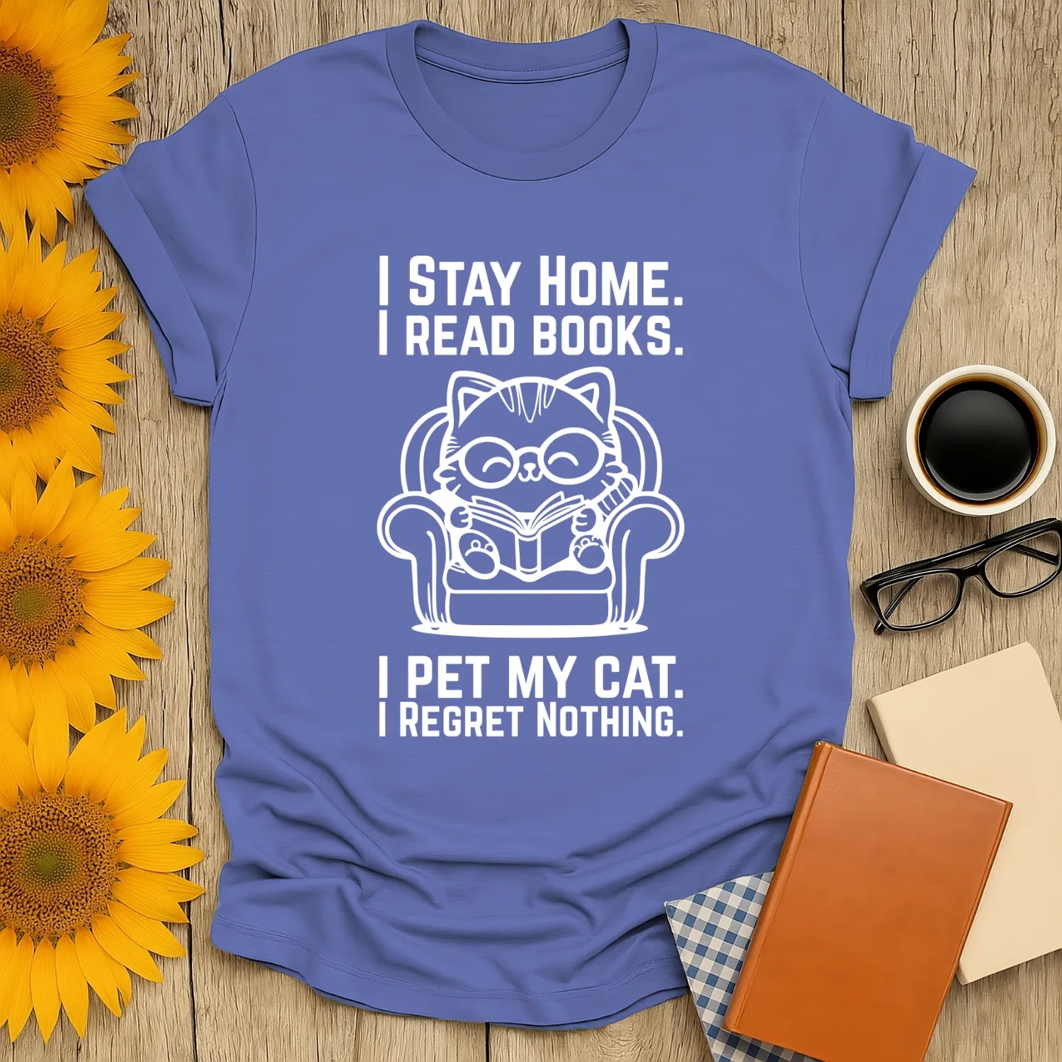 Cozy blue t-shirt featuring a cat reading a book, perfect for book lovers who enjoy humor and relaxation.