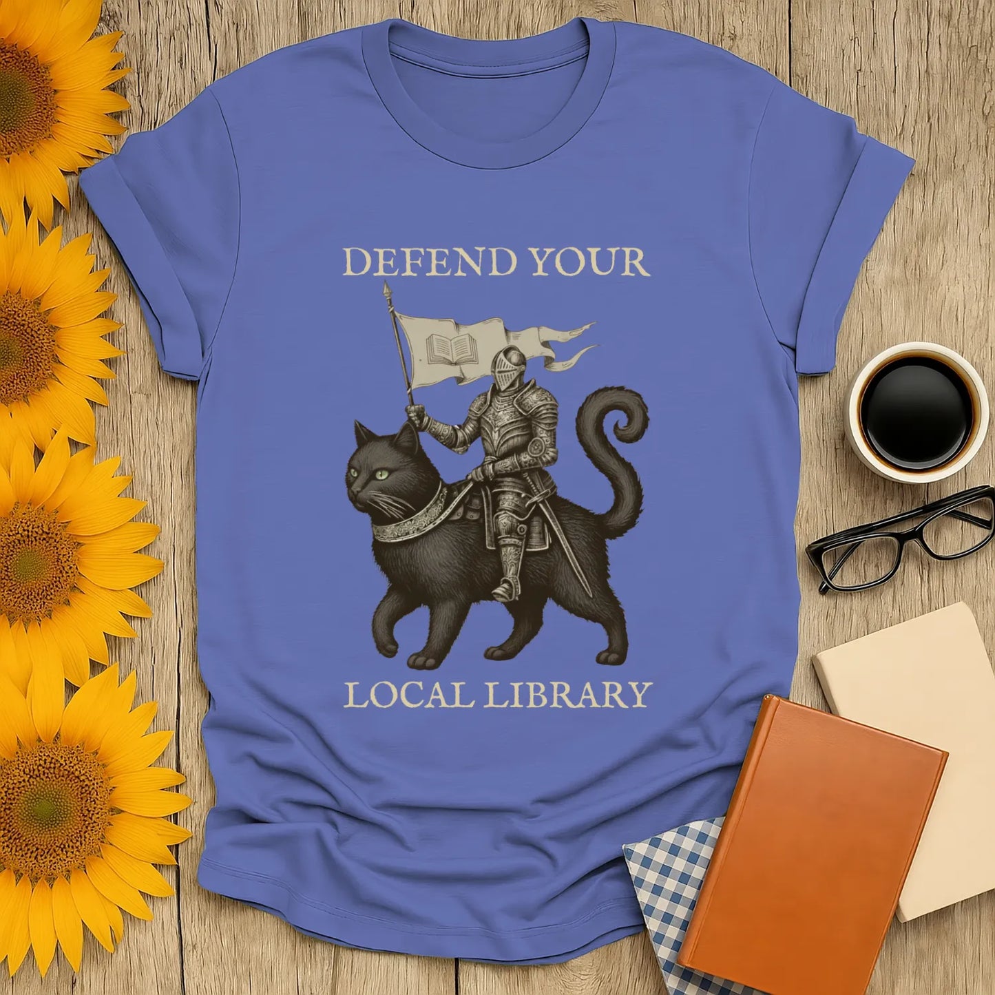 Library Defender T-Shirt featuring a knight on a cat with the text "Defend Your Local Library"—perfect for book lovers.