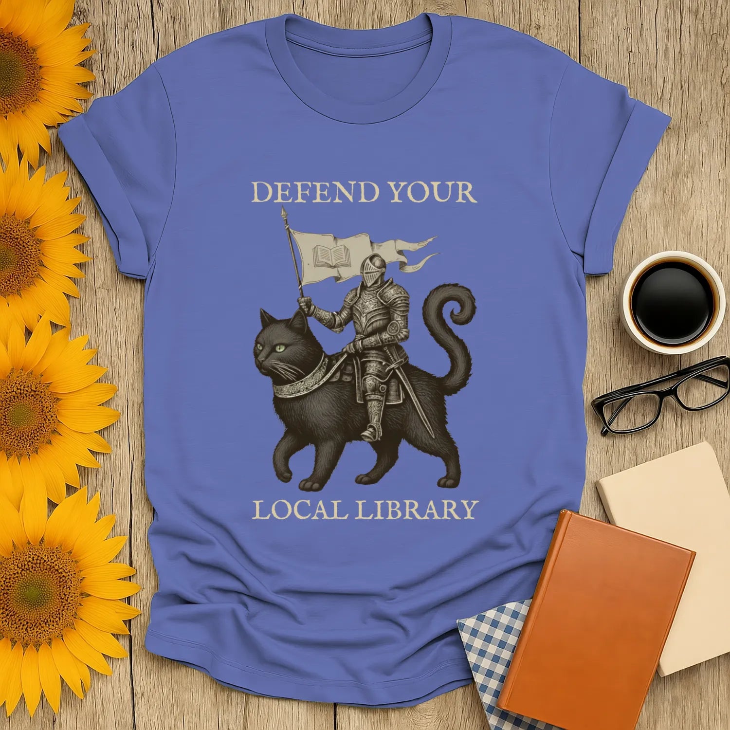 Library Defender T-Shirt featuring a knight on a cat with the text "Defend Your Local Library"—perfect for book lovers.