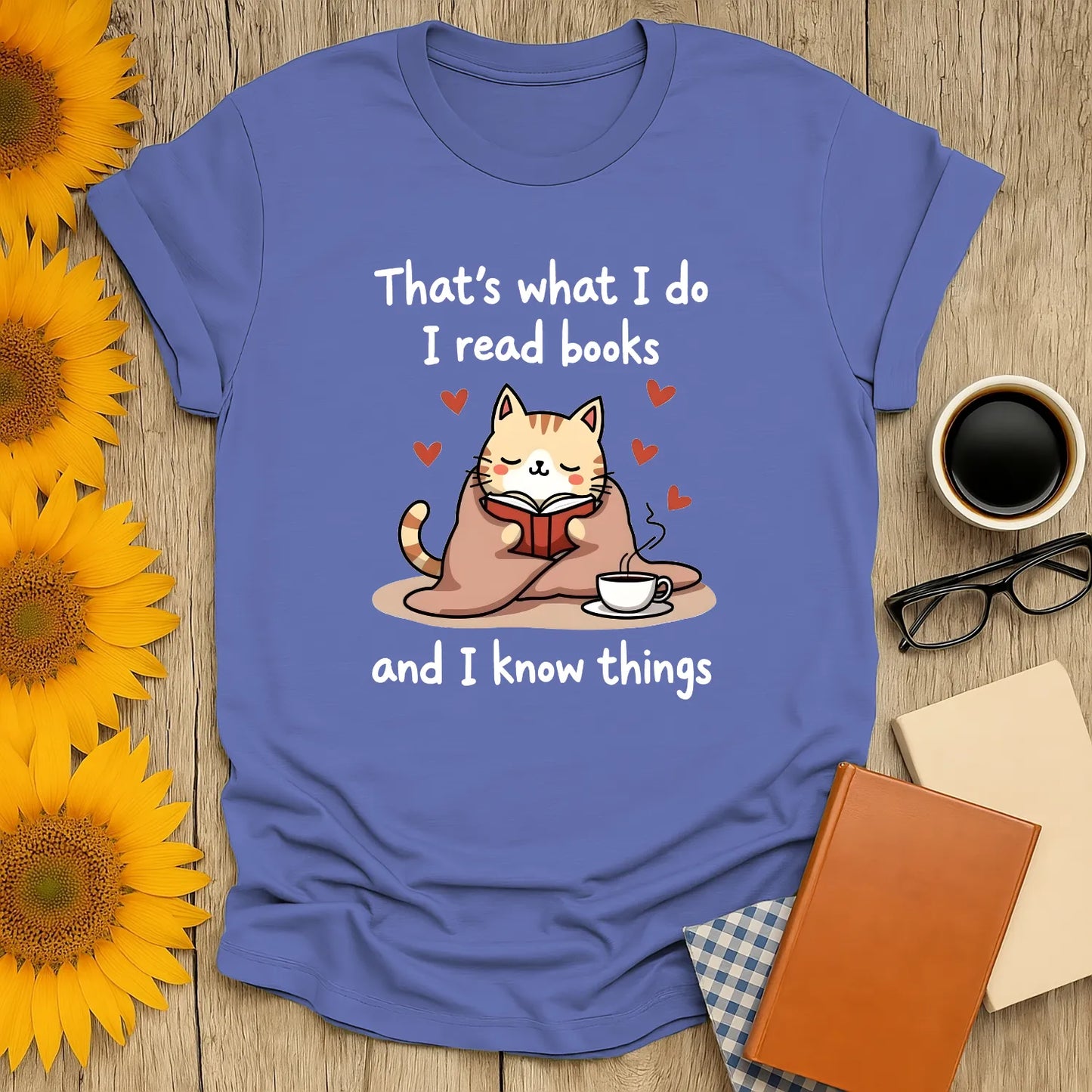 Cozy kitty reading a book with a cup, captioned 'I read books and I know things' - perfect funny reading tee for book lovers.