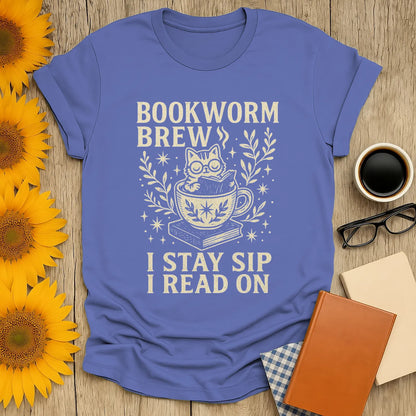 Bookworm Brew T-Shirt featuring a cozy cat in a teacup, perfect for book lovers who enjoy reading, coffee, and cats.