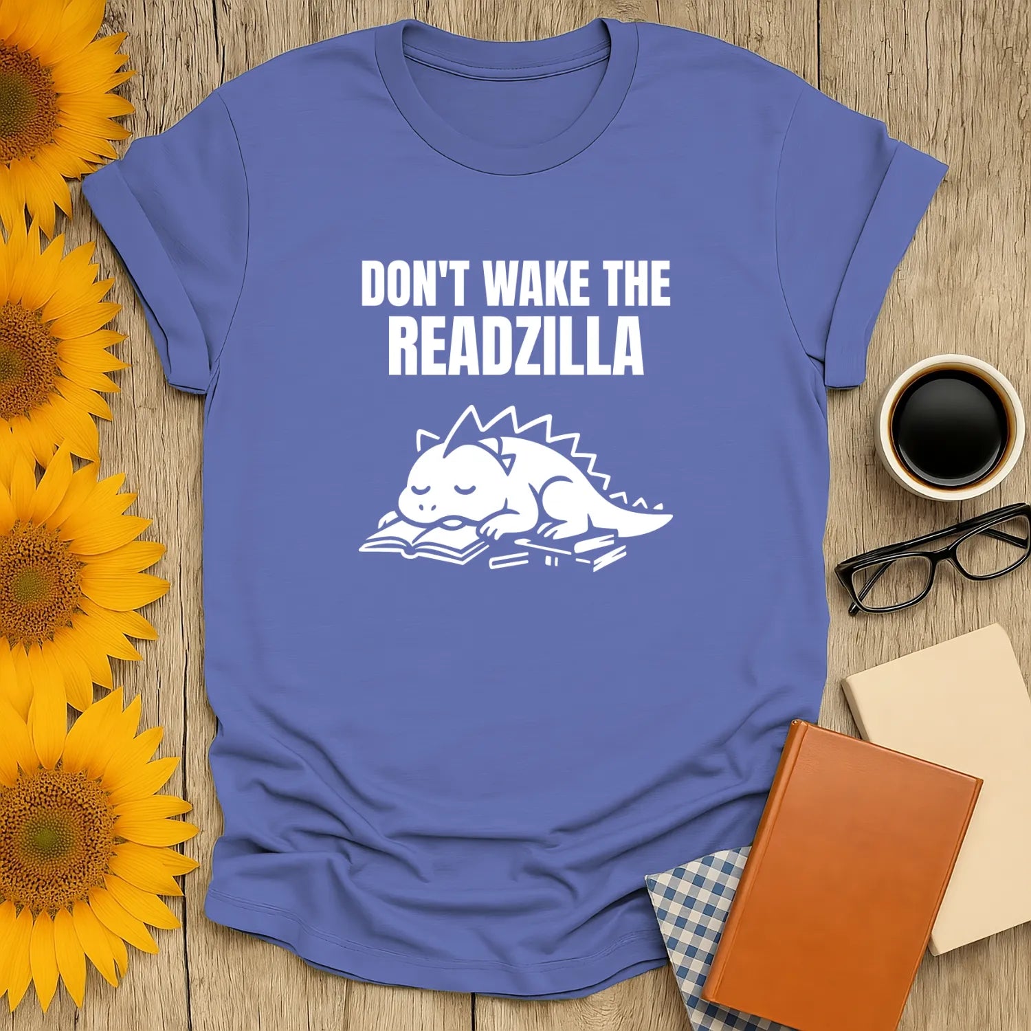 Funny book lover shirt showing a sleepy dinosaur with text 'Don't Wake the Readzilla' — perfect for cozy reading and napping.
