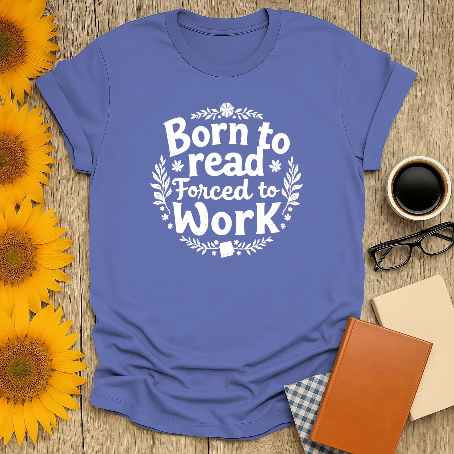 Ink & Imagination T-Shirt in soft blue, featuring 'Born to Read Forced to Work' design. Ideal cozy reading outfit for book lovers. 📖