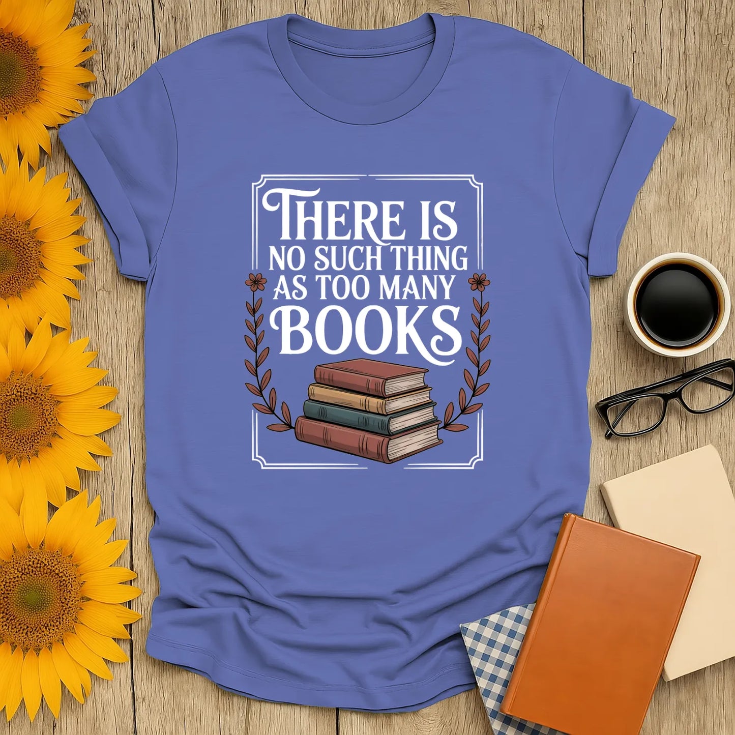 Funny reading tee featuring stacked books and text 'There is no such thing as too many books' perfect for cozy book lovers.