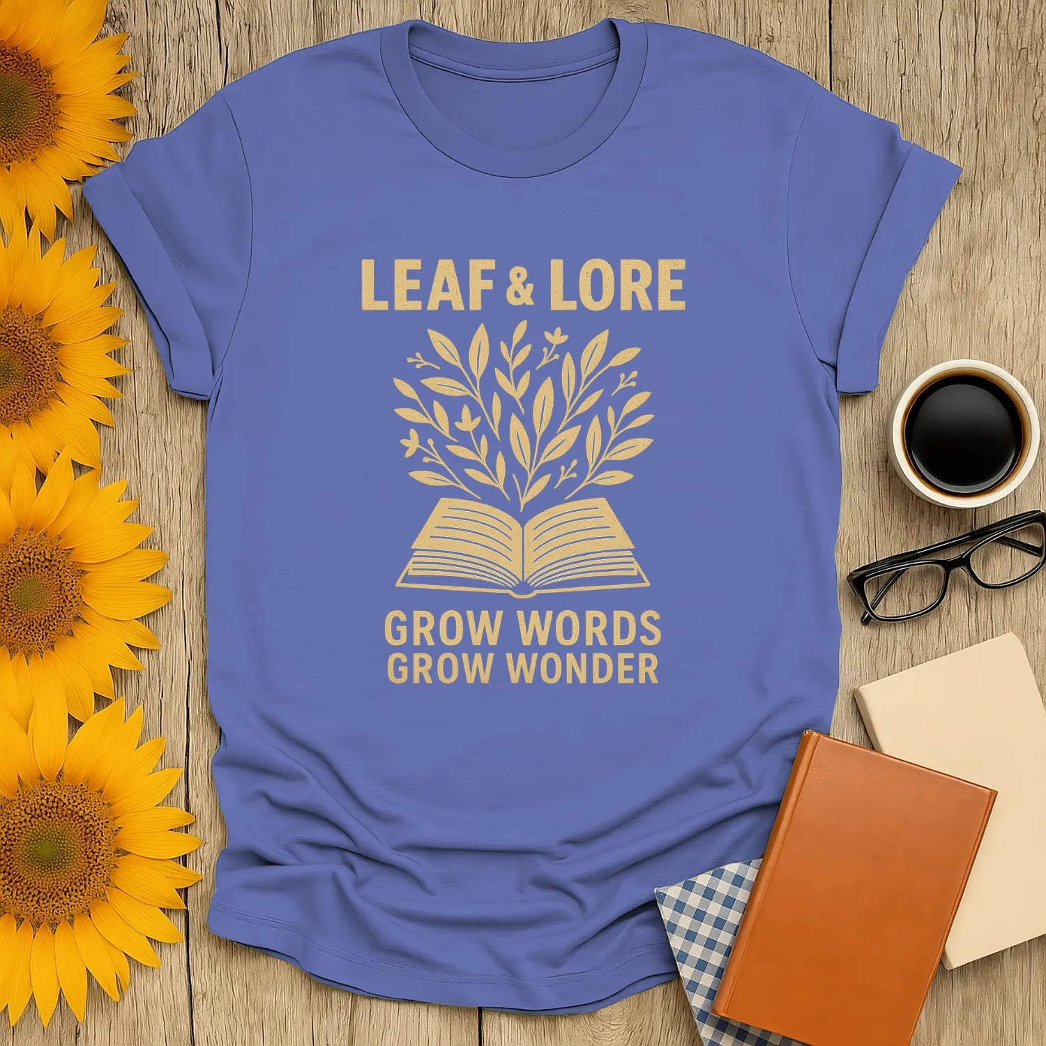 Leaf & Lore tee with golden leaves sprouting from an open book, captioned 'Grow Words Grow Wonder'—a cozy shirt for book lovers.