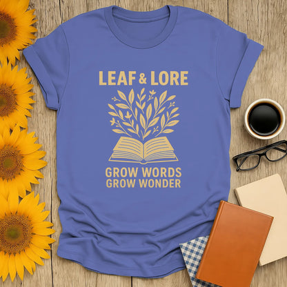Leaf & Lore tee with golden leaves sprouting from an open book, captioned 'Grow Words Grow Wonder'—a cozy shirt for book lovers.
