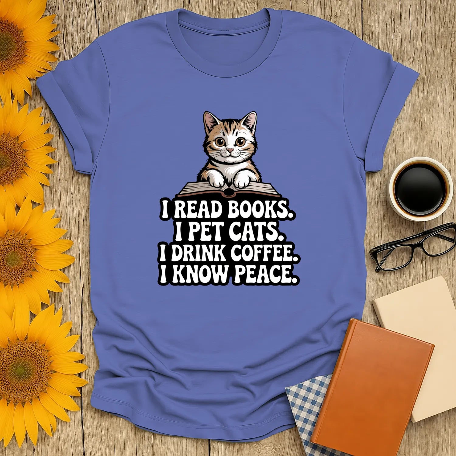 Cozy blue book lover shirt with cat illustration and text: 'I read books. I pet cats. I drink coffee. I know peace.' Perfect gift for readers.