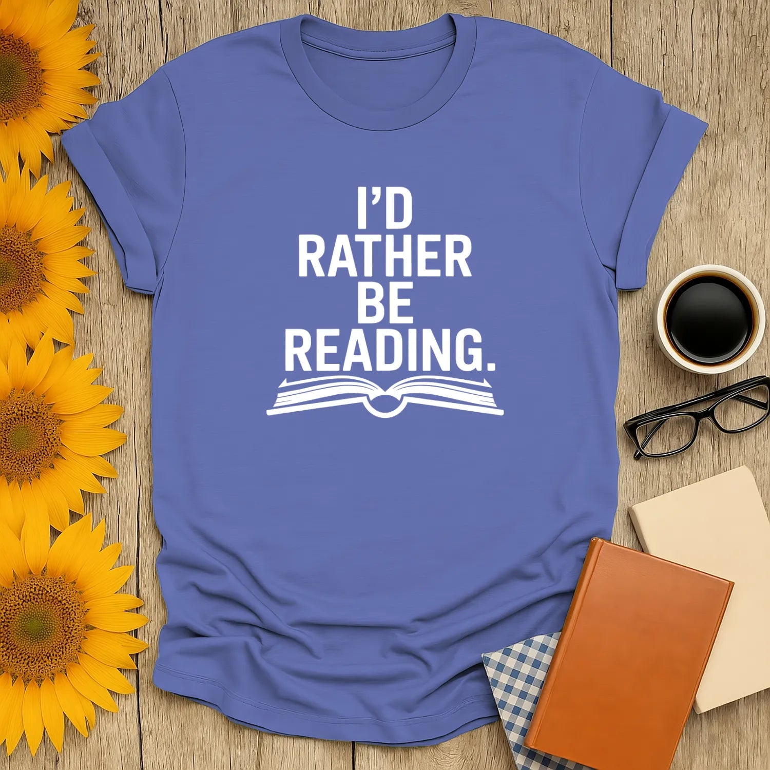 Light blue unisex tee featuring the phrase "I’d Rather Be Reading" with an open book graphic; perfect gift for book lovers!
