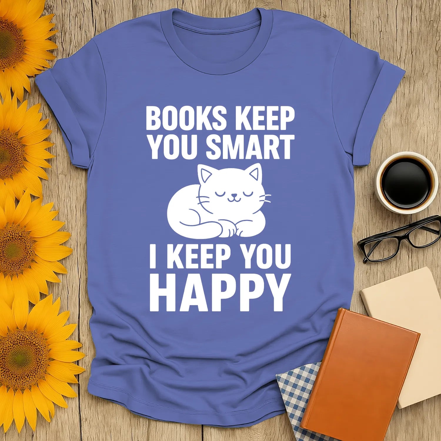 Cozy blue t-shirt with a cute sleeping cat illustration and text: 'Books Keep You Smart, I Keep You Happy' for book lovers.