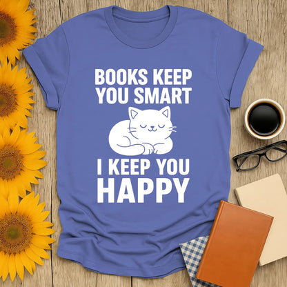 Cozy blue t-shirt with a cute sleeping cat illustration and text: 'Books Keep You Smart, I Keep You Happy' for book lovers.