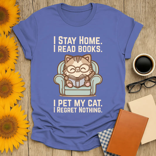 Comfy Cat Reader T-Shirt features an adorable cat in glasses reading on a blue armchair, perfect for book lovers and cat enthusiasts.