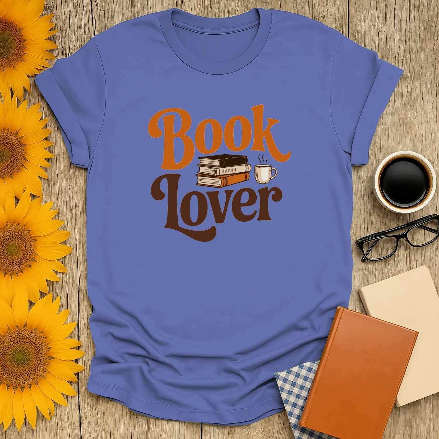 Cozy blue Book Lover t-shirt with stacked books and a coffee cup, perfect gift for bookworms who adore reading.