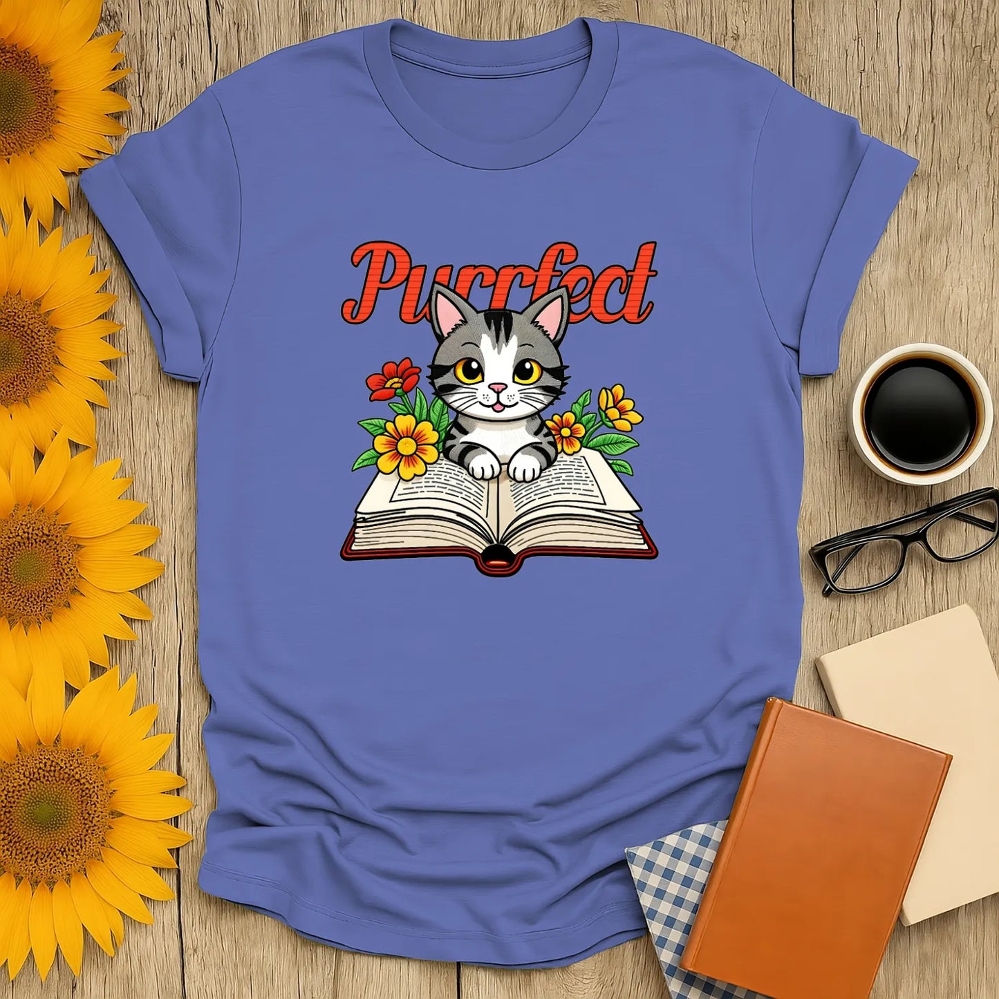 Purrfect Page T-Shirt featuring a cute kitten on an open book surrounded by flowers—ideal for cat-loving bookworms!