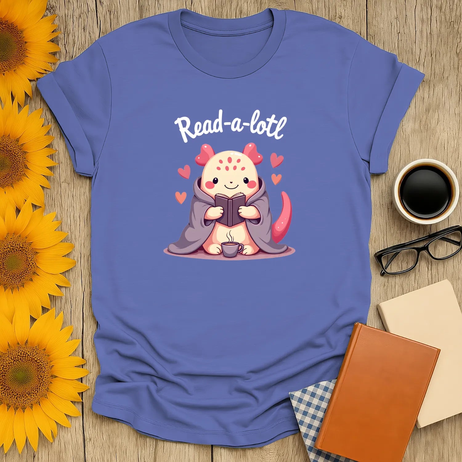 Read-a-lotl T-Shirt featuring an axolotl reading by a cozy setup, perfect for book lovers and introverts. ☕️✨