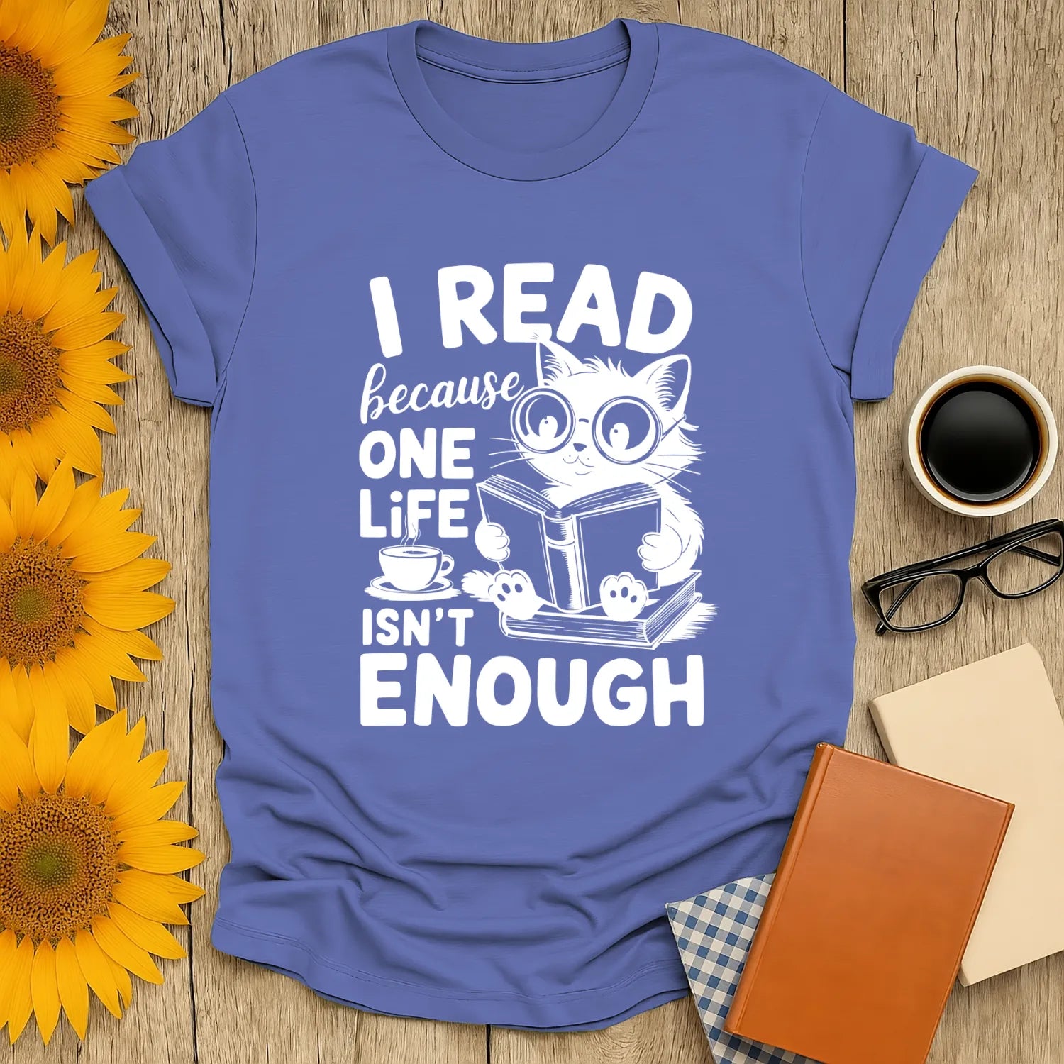 Cozy blue cat reading tee with text 'I read because one life isn't enough'—perfect gift for book lovers and cat fans.