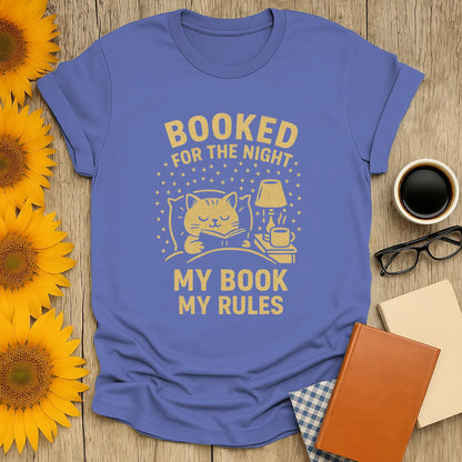 Cozy cat with book and coffee on the Booked for the Night t-shirt; perfect gift for book lovers and cat fans.
