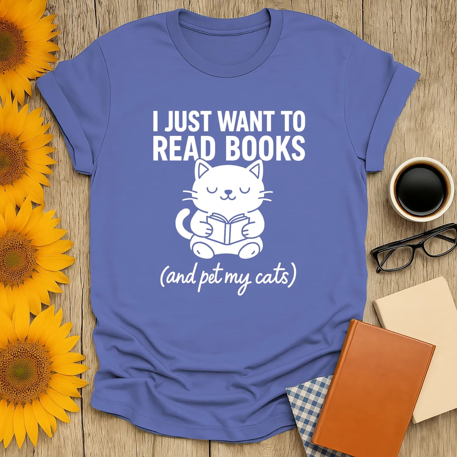 Blue t-shirt featuring a cute cat reading with text: "I Just Want to Read Books (and pet my cats)" perfect for book lovers.