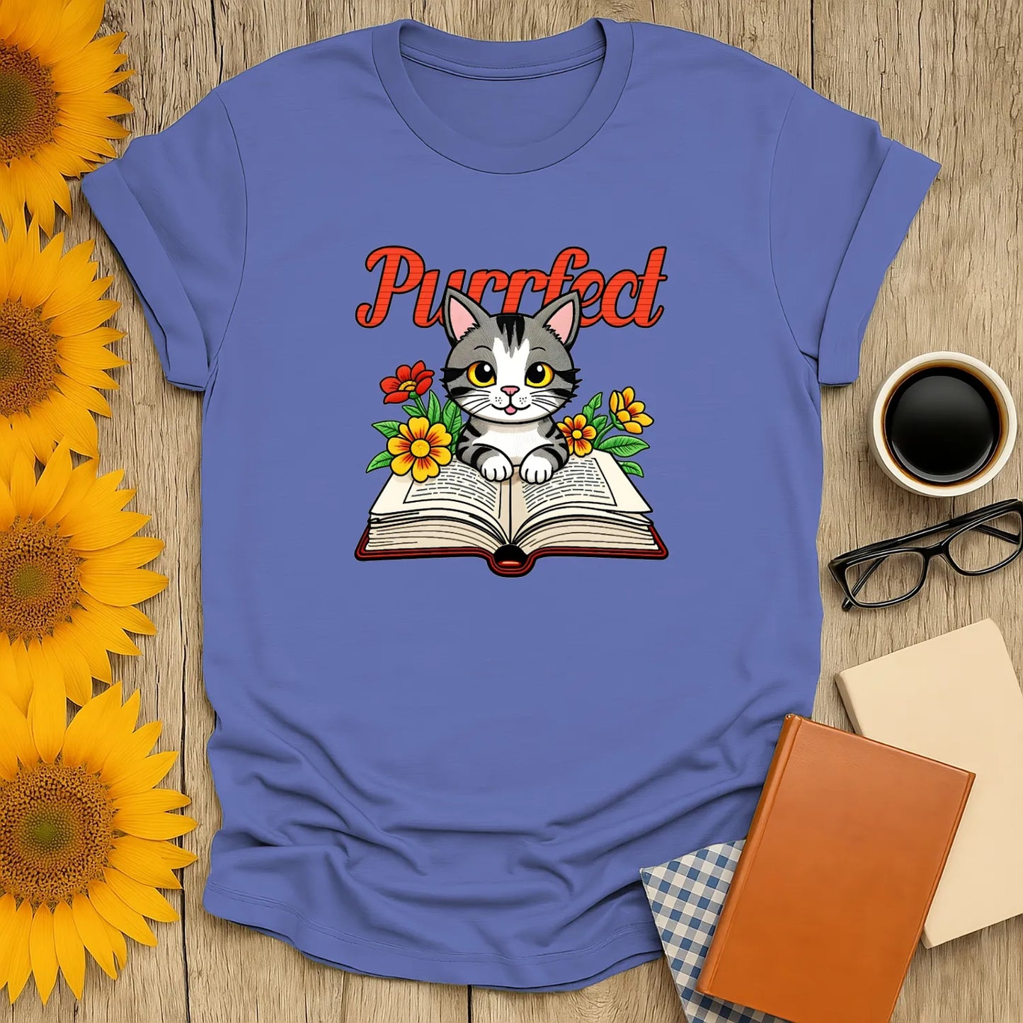 Purrfect Page T-Shirt featuring a kitten on an open book with flowers, perfect for book lovers and cozy reading vibes. 📖