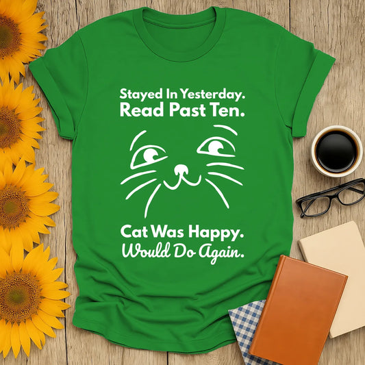 Humorous green t-shirt for book lovers with cat face and text: "Stayed In Yesterday. Read Past Ten. Cat Was Happy."