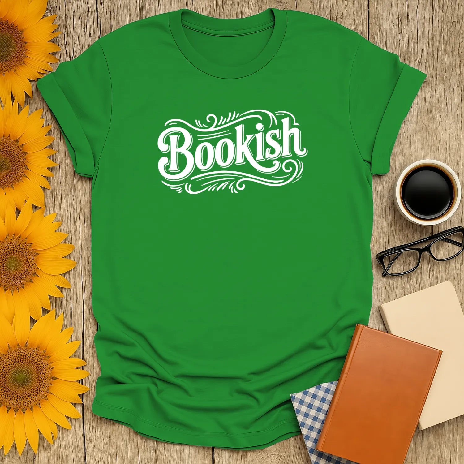 Bookish green t-shirt featuring whimsical lettering; perfect gift for readers who love cats, coffee, or tea.